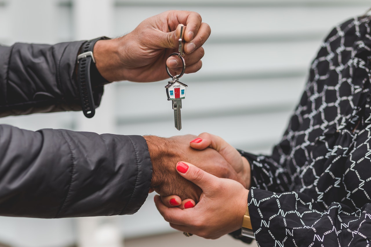 someone handing keys to new owner